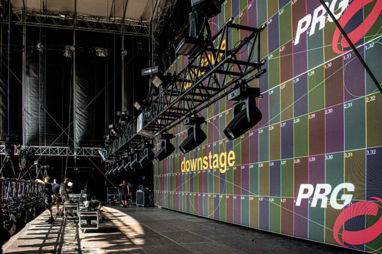 Independent AV technical production setup with lighting and stage at corporate event