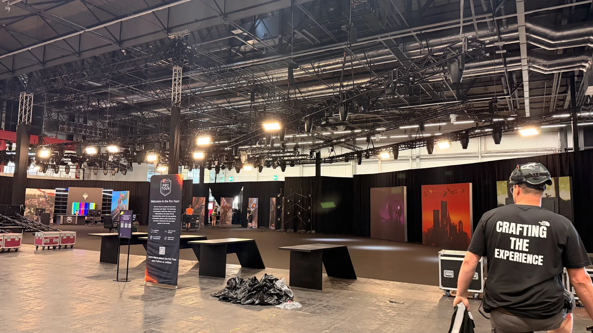 Crew member on the floor during the stage build for MagicCon 2026 in RAI Amsterdam